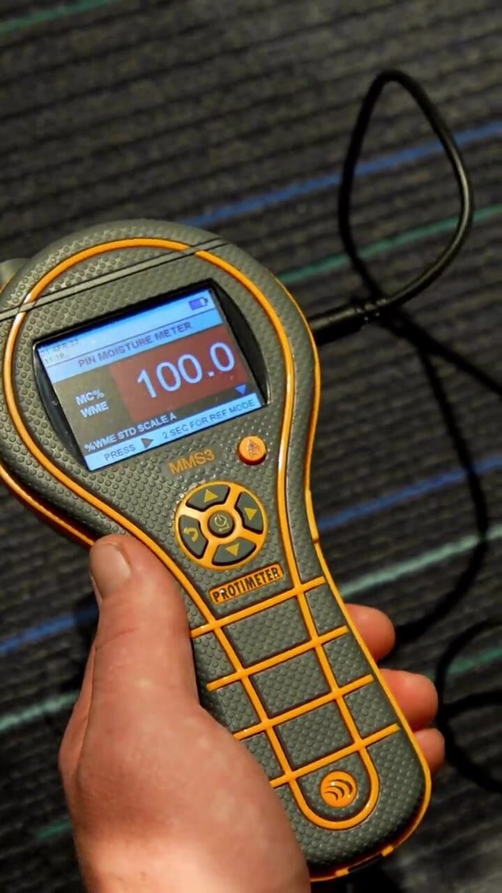 A moisture meter reading taken on wet carpet